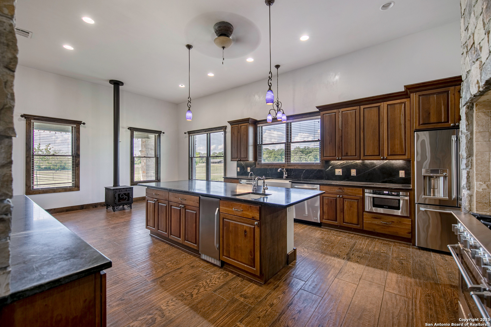 9560 Old Colony Line Road Dale, TX 78616 - Photo 13 of 41 an open kitchen with wooden floor and stainless steel appliances