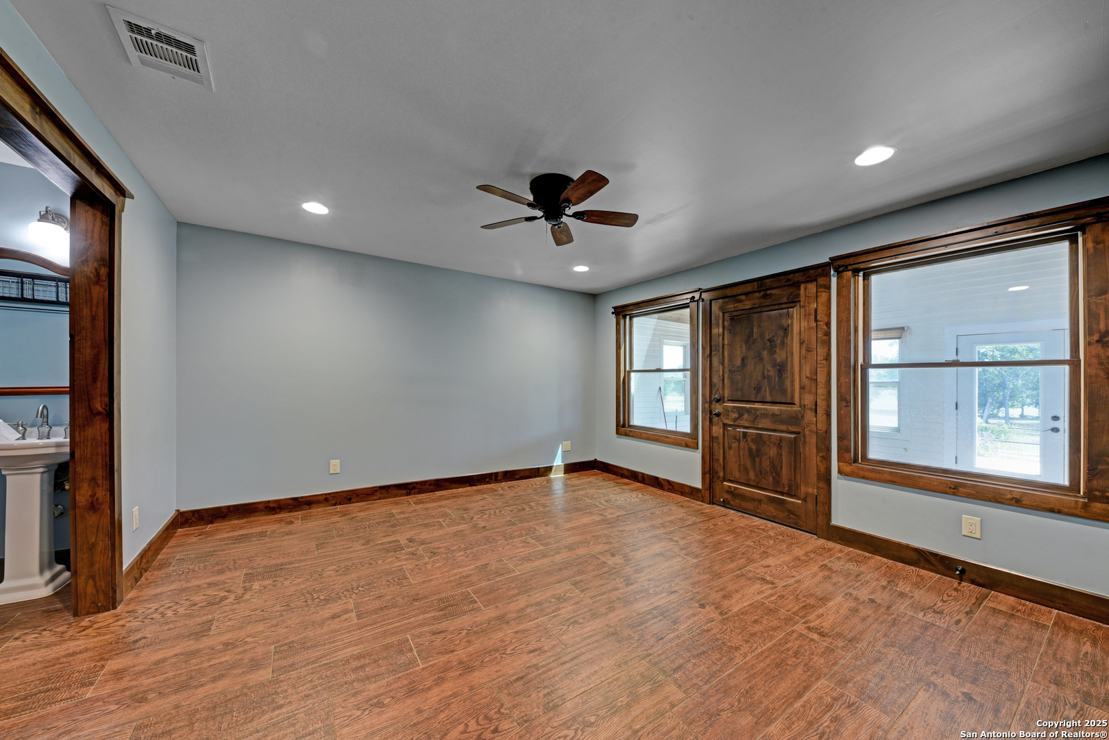 9560 Old Colony Line Road Dale, TX 78616 - Photo 19 of 41 an empty room with windows and ceiling fan