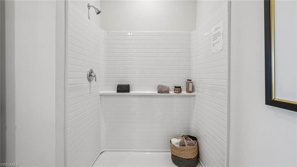 17584 Shade Tree Loop Punta Gorda, FL 33982 - Photo 19 of 35 Tiled walk-in shower featuring a chrome showerhead and control handle