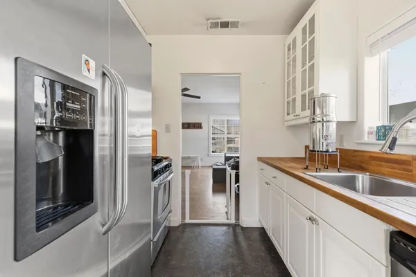 a kitchen with a refrigerator and a sink
