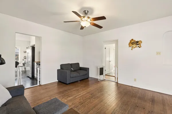 a living room with furniture and a ceiling fan