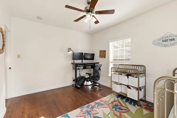 a view of a workspace with furniture and a window