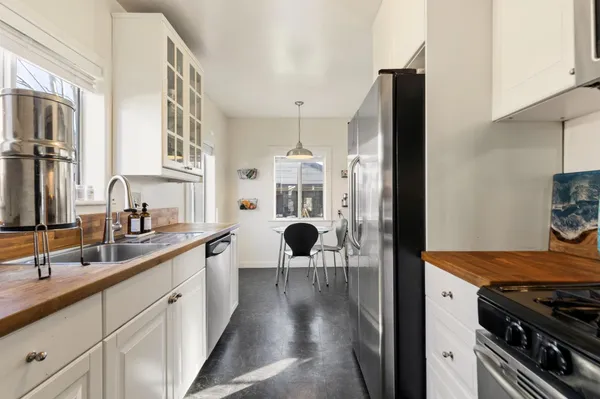 a kitchen with stainless steel appliances a sink stove and refrigerator