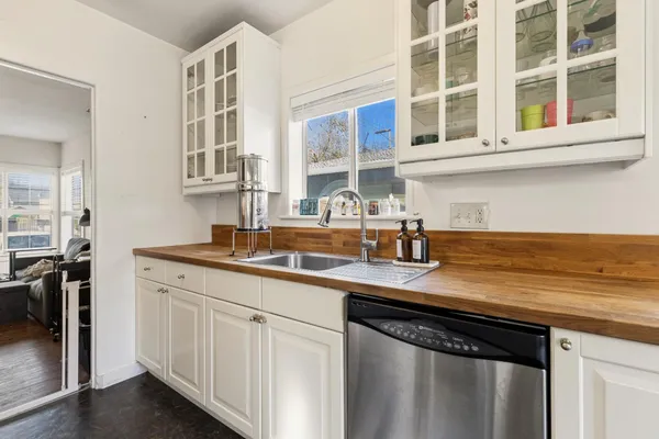 a kitchen with stainless steel appliances granite countertop a sink stove and cabinets