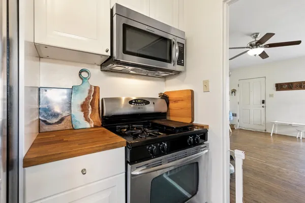 a kitchen with stainless steel appliances granite countertop a stove and a microwave