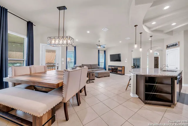 a large kitchen with a table and chairs