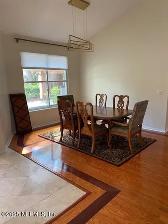 a view of a dining room with furniture window and wooden floor