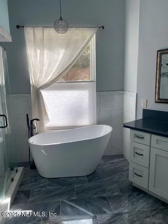a bathroom with a bathtub and window
