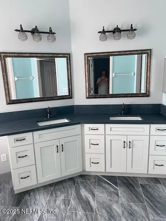 a bathroom with a sink and a mirror