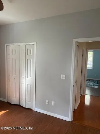 a view of a hallway with wooden floor
