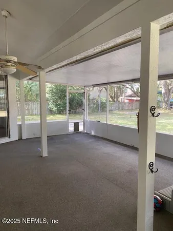 a view of empty room with windows