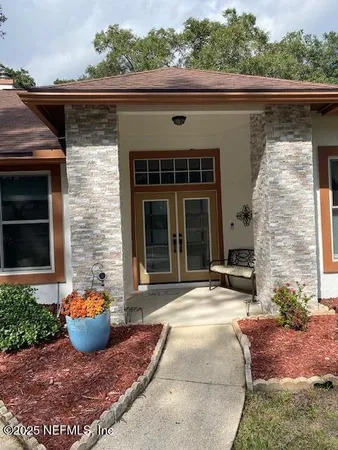 a view of a patio with table and chairs and potted plants