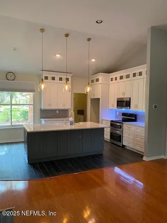 a large kitchen with lots of counter space and windows