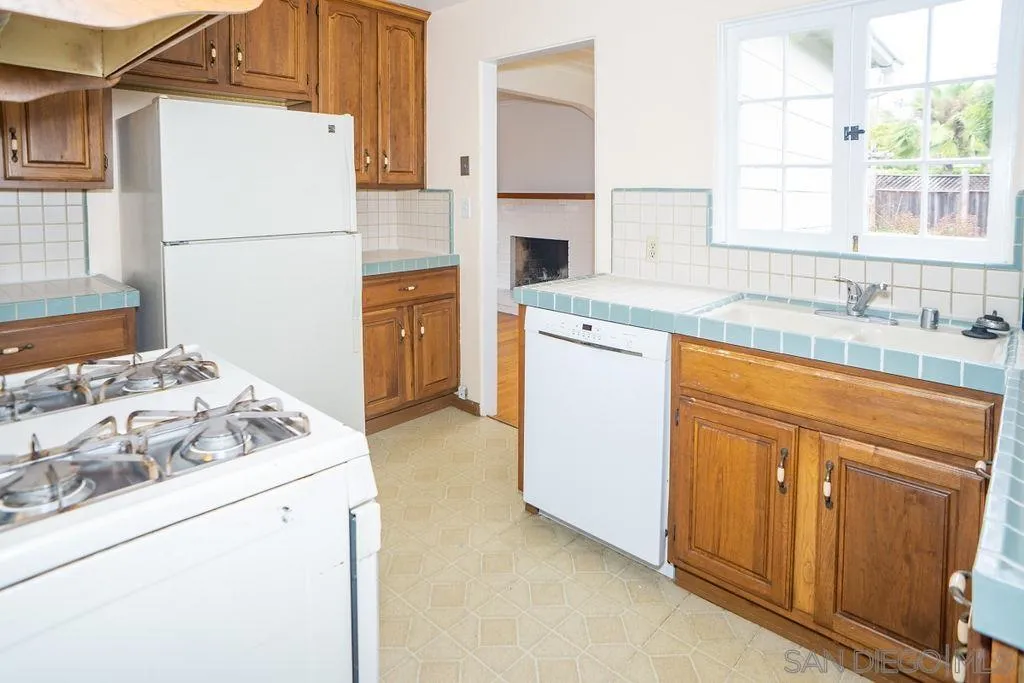 527 Forward Street La Jolla, CA 92037 - Photo 15 of 42 a kitchen with a sink stove and refrigerator