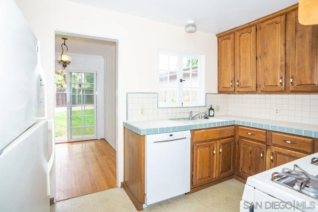 527 Forward Street La Jolla, CA 92037 - Photo 18 of 42 a kitchen with a sink stove and cabinets