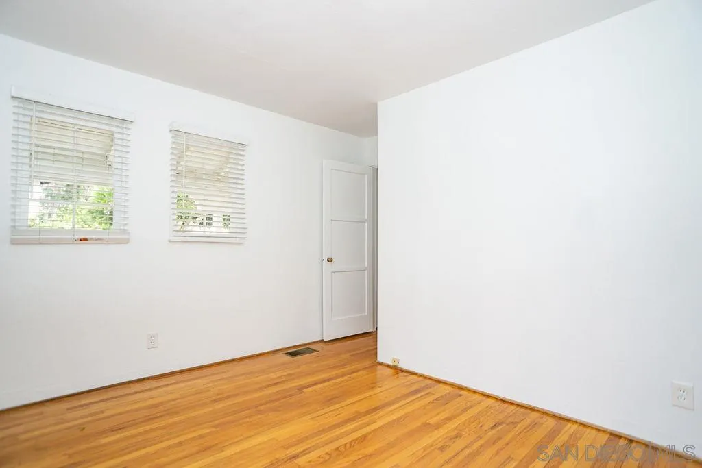 527 Forward Street La Jolla, CA 92037 - Photo 28 of 42 a view of an empty room with wooden floor and a window