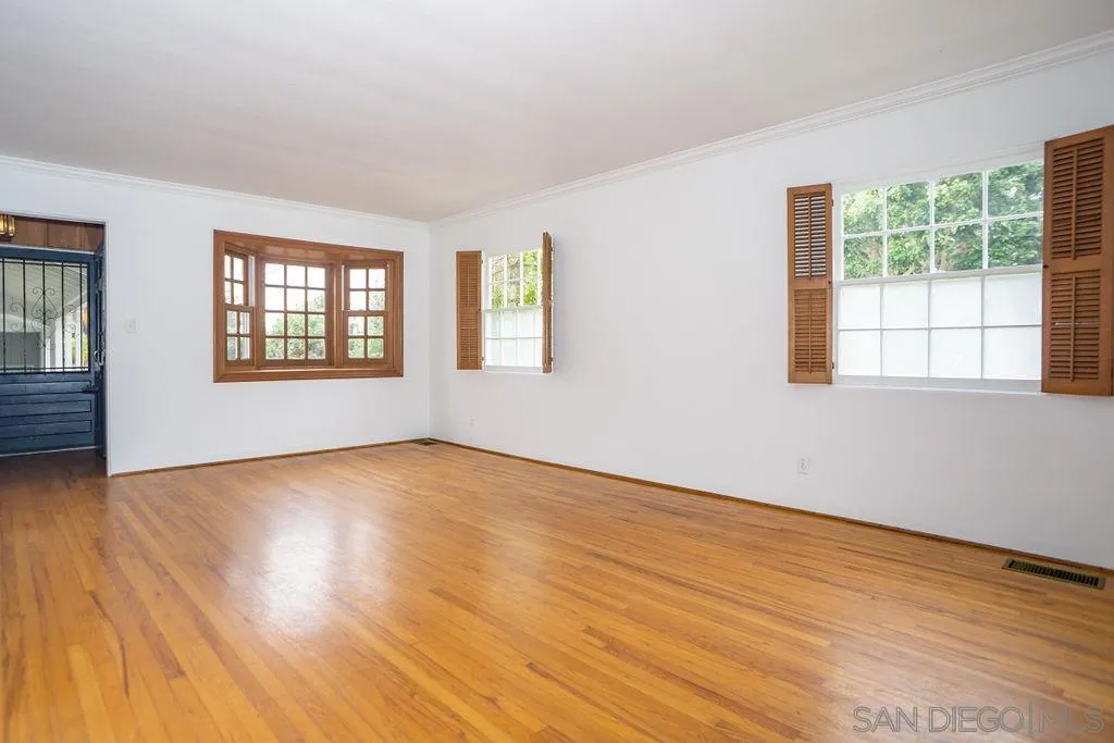 527 Forward Street La Jolla, CA 92037 - Photo 5 of 42 a view of an empty room with wooden floor and a window