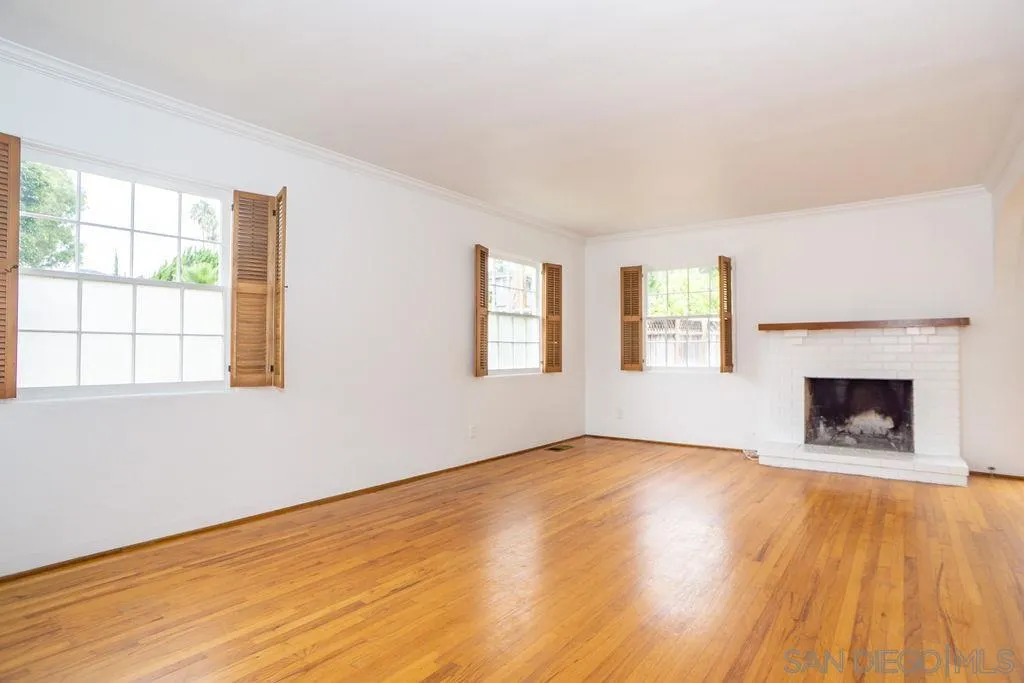 527 Forward Street La Jolla, CA 92037 - Photo 6 of 42 a view of an empty room with window and wooden floor