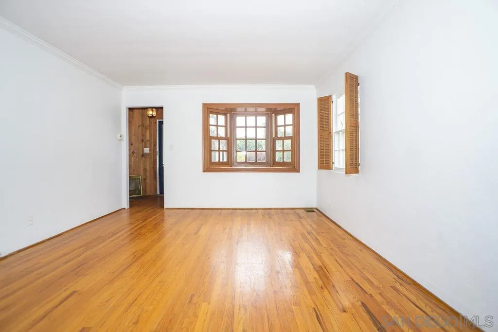527 Forward Street La Jolla, CA 92037 - Photo 7 of 42 an empty room with wooden floor and windows