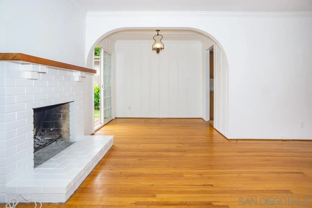 527 Forward Street La Jolla, CA 92037 - Photo 8 of 42 a view of empty room with wooden floor and fireplace