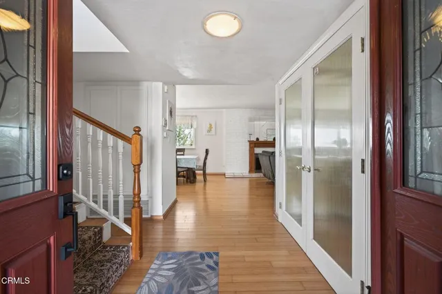 a view of a hallway with wooden floor windows and entryway