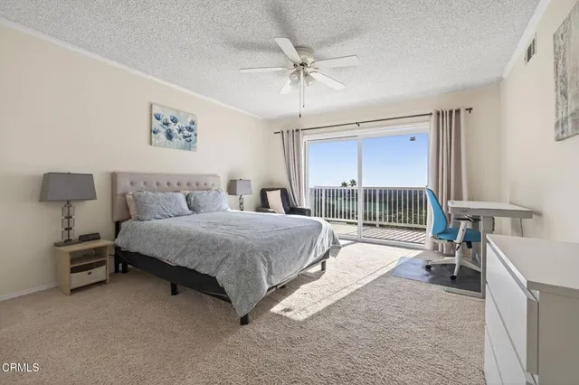 a spacious bedroom with a bed and a chandelier