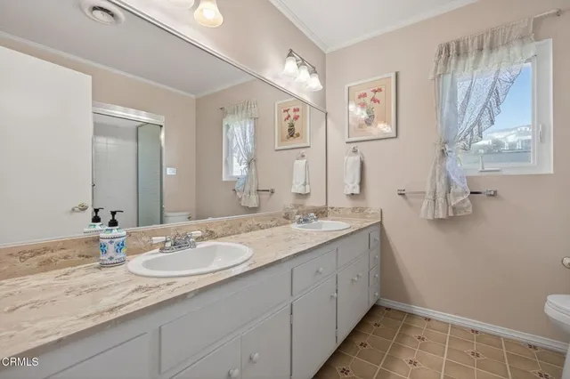 a bathroom with a granite countertop sink a toilet and a mirror