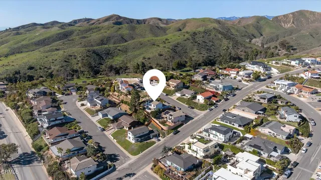 an aerial view of a house with a mountain view