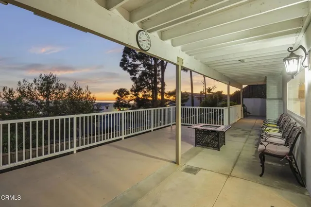 a view of a chairs and table in the balcony