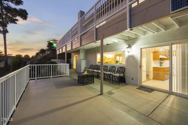 a view of a porch with furniture and a gate