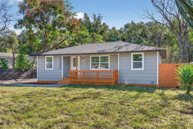 a front view of a house with yard and green space