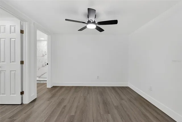 a front view of a house with a big yard and large tree