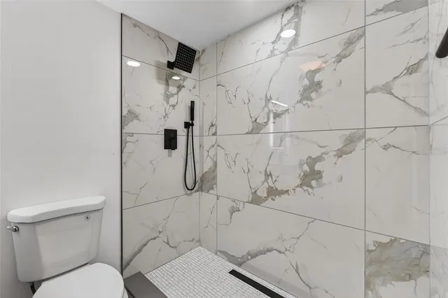 an aerial view of residential house with outdoor space and trees all around