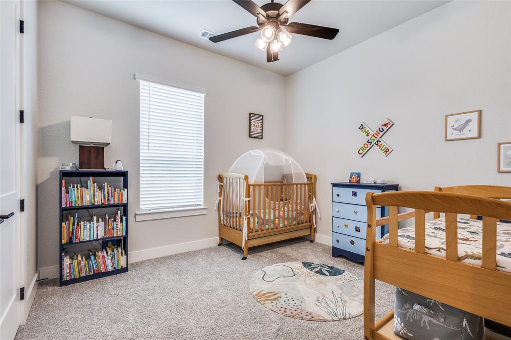 2255 County Road 377 Van Alstyne, TX 75495 - Photo 17 of 35 a bedroom with furniture and a book shelf