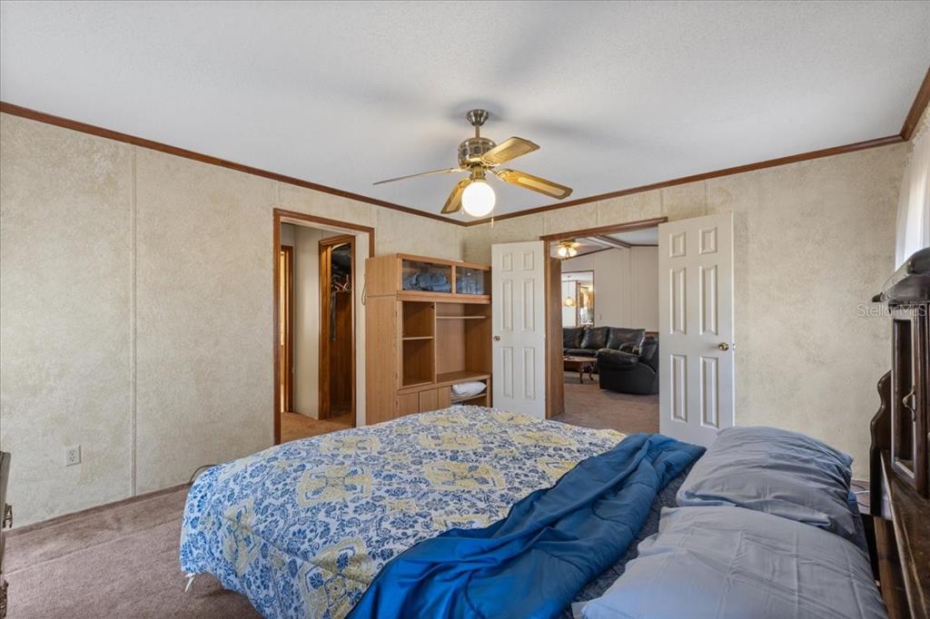 4945 Southwest Highway 358 Steinhatchee, FL 32359 - Photo 12 of 35 a bedroom with a bed and a dresser with rug