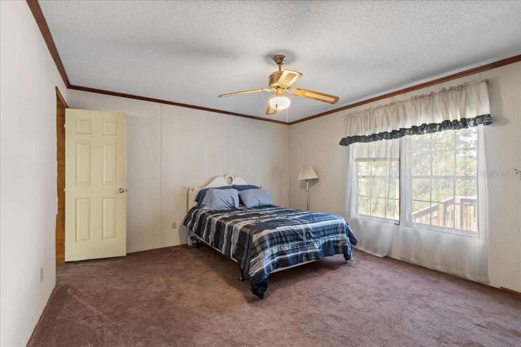 4945 Southwest Highway 358 Steinhatchee, FL 32359 - Photo 16 of 33 a spacious bedroom with a bed and a window