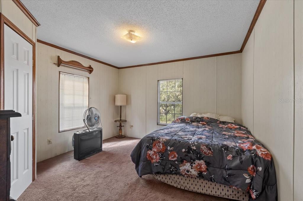 4945 Southwest Highway 358 Steinhatchee, FL 32359 - Photo 19 of 35 a bedroom with a bed and a window