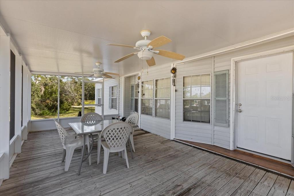 4945 Southwest Highway 358 Steinhatchee, FL 32359 - Photo 2 of 33 a dining room with furniture a chandelier and wooden floor