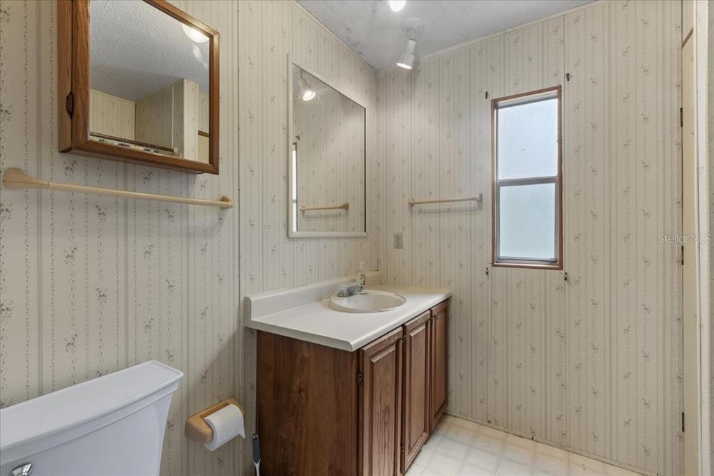 4945 Southwest Highway 358 Steinhatchee, FL 32359 - Photo 23 of 35 a bathroom with a sink a toilet and mirror