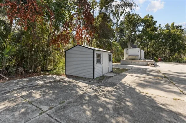 a view of a house with a tree in the background