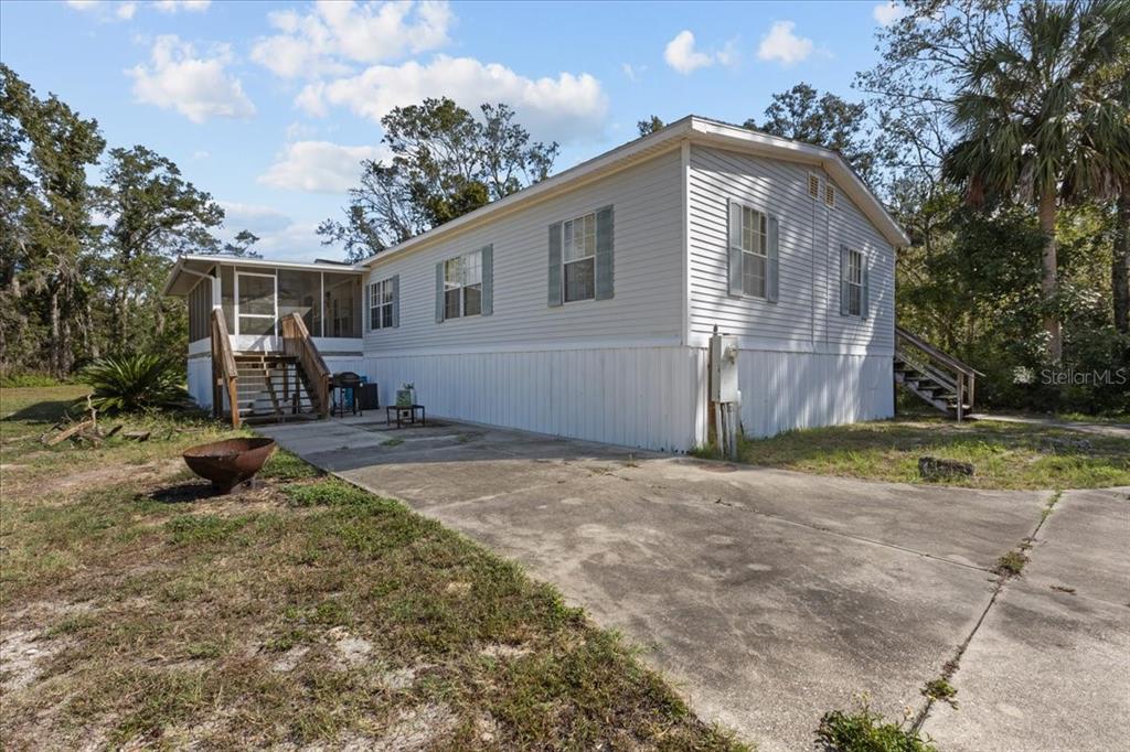 4945 Southwest Highway 358 Steinhatchee, FL 32359 - Photo 26 of 35 a front view of a house with a yard and garage