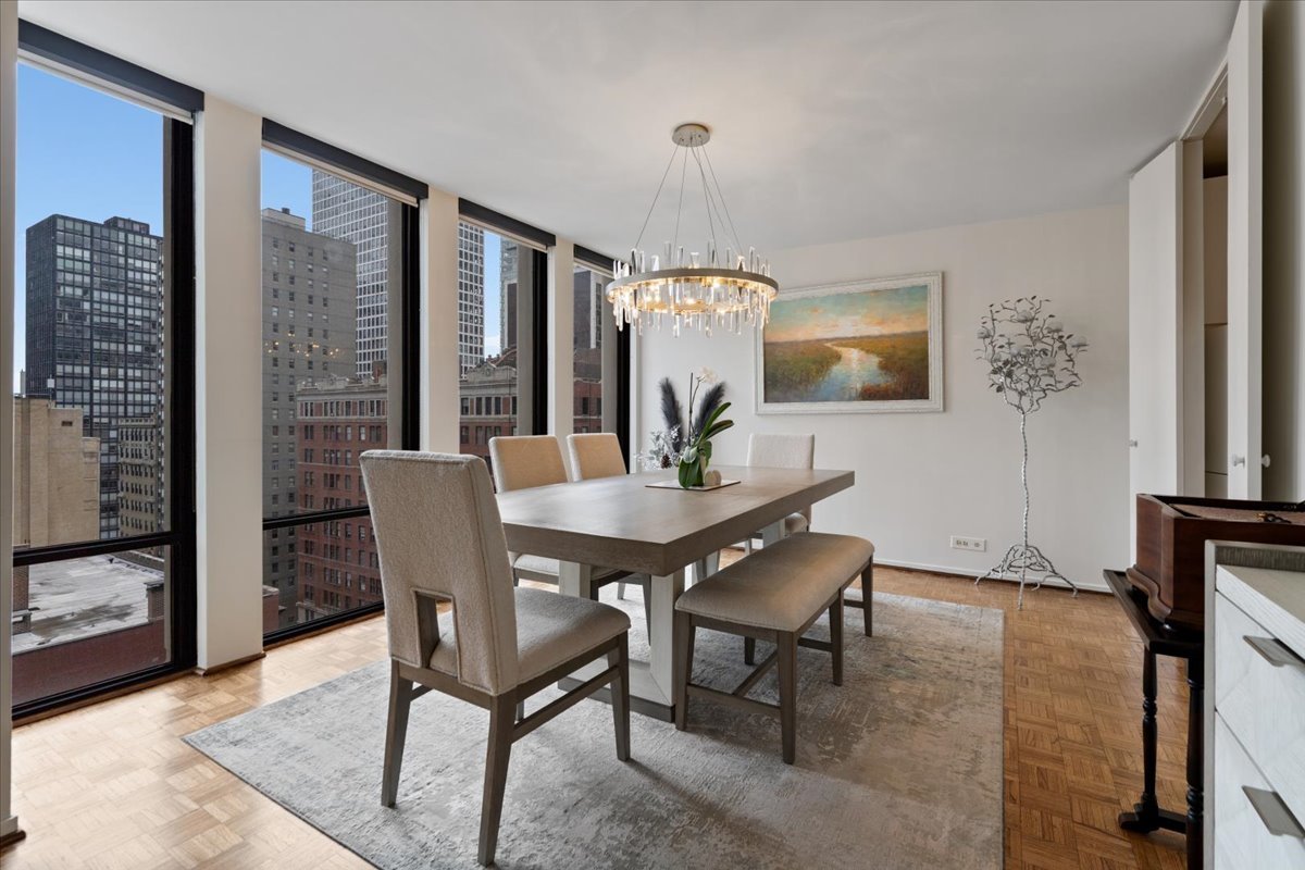 200 East Delaware Place, Unit 13C Chicago, IL 60611 - Photo 13 of 31 a dining room with furniture and window