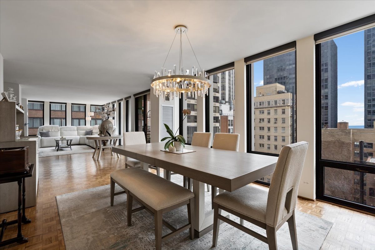 200 East Delaware Place, Unit 13C Chicago, IL 60611 - Photo 14 of 31 a dining room with furniture window and wooden floor