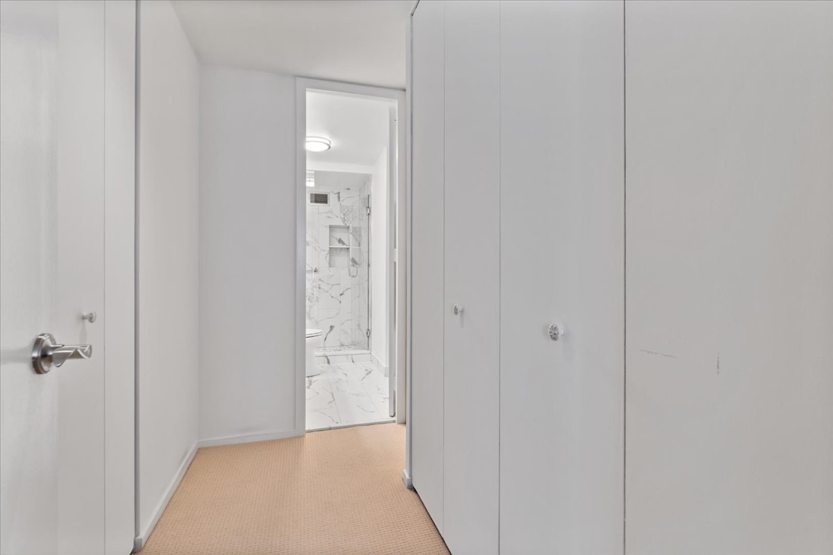 200 East Delaware Place, Unit 13C Chicago, IL 60611 - Photo 19 of 31 a view of a hallway with wooden floor