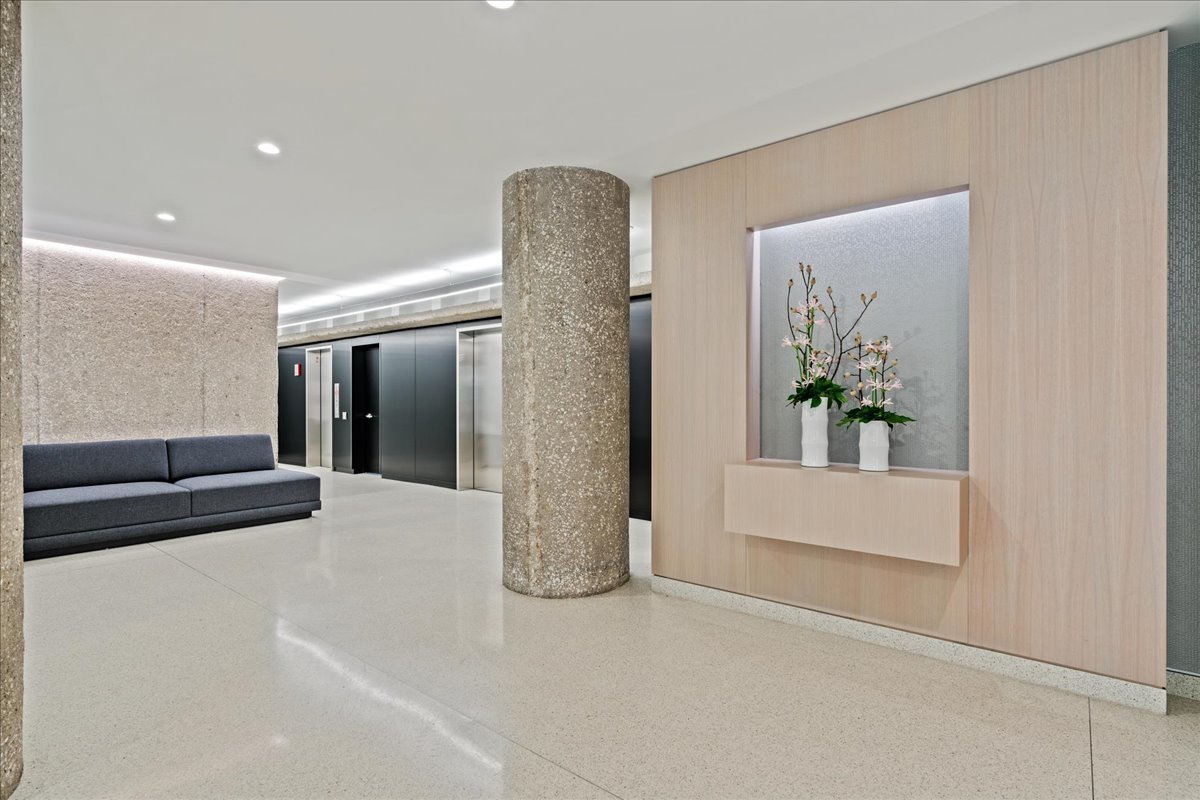 200 East Delaware Place, Unit 13C Chicago, IL 60611 - Photo 4 of 31 a view of hallway with furniture and a chandelier