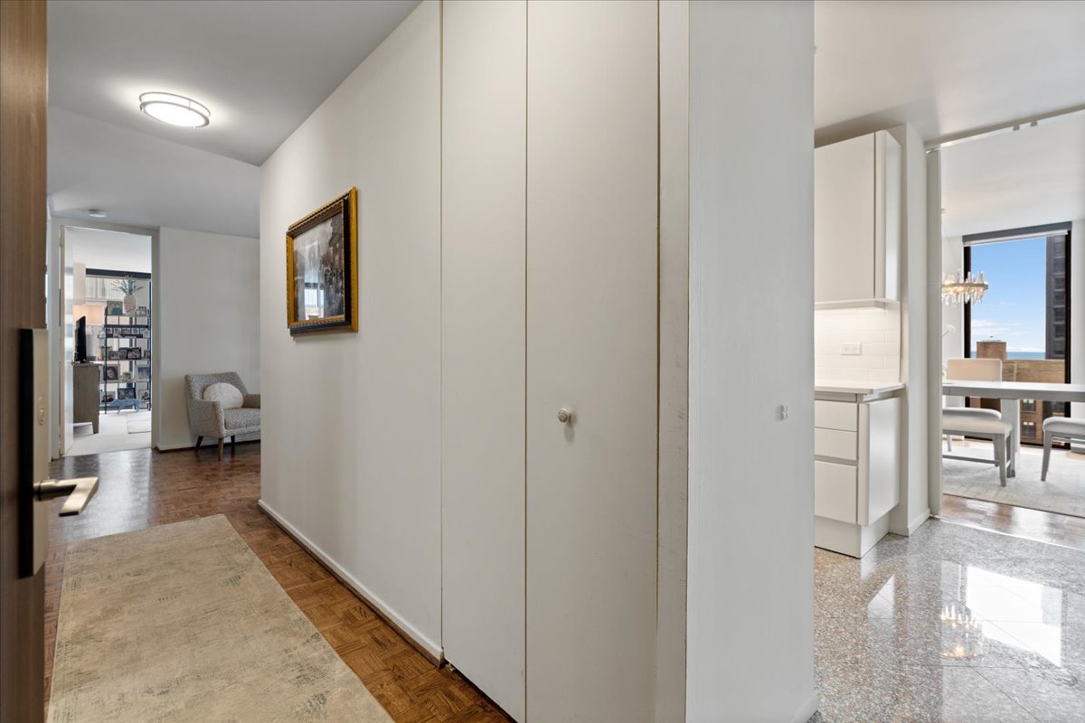 200 East Delaware Place, Unit 13C Chicago, IL 60611 - Photo 6 of 31 a view of a hallway with living room and wooden floor