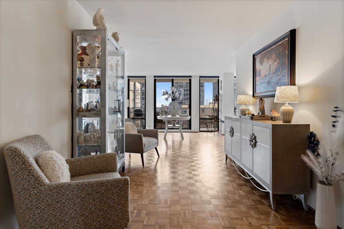 200 East Delaware Place, Unit 13C Chicago, IL 60611 - Photo 8 of 31 a living room with furniture and wooden floor