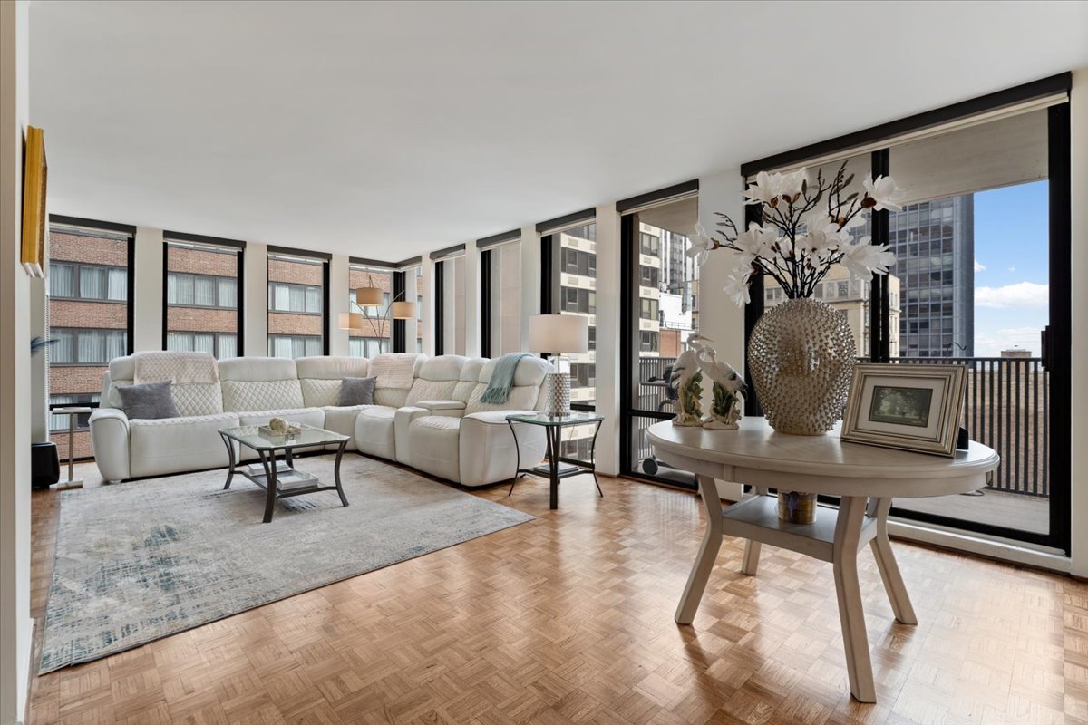 200 East Delaware Place, Unit 13C Chicago, IL 60611 - Photo 9 of 31 a living room with furniture and wooden floor