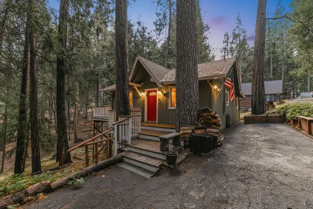 a view of a house with backyard and sitting area