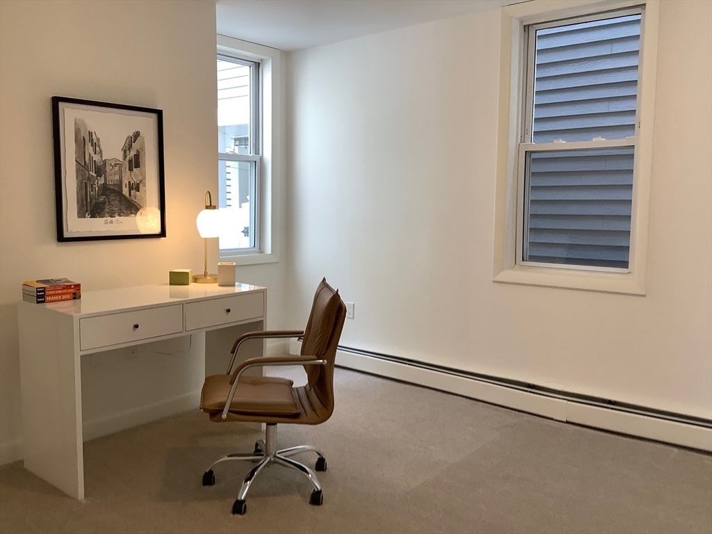 18 R Polk Street Boston, MA 02129 - Photo 8 of 19 a view of a workspace with furniture and a window